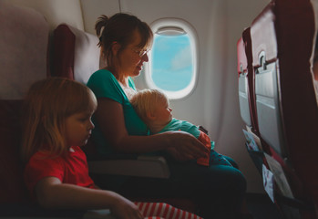 mother with two kids travel by plane