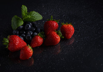 Fruits on black background smoothie ware