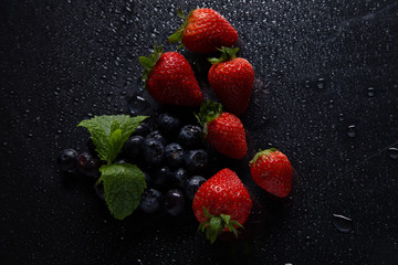 Fruits on black background smoothie ware