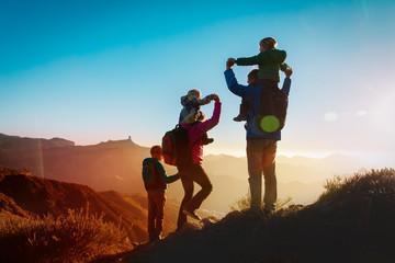 happy family travel in mountains at sunset