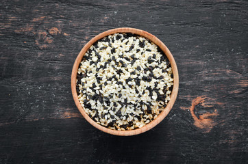 Sesame. Set of black and white sesame seeds. On a black background. Top view. Free copy space.