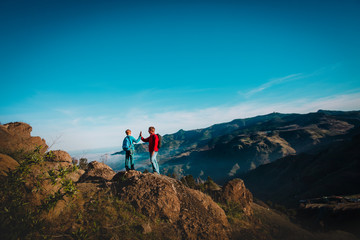 Fototapeta premium father and son travel in nature, family hiking in mountains