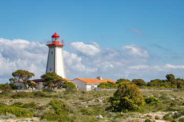 Fototapeta na wymiar Lighthouse placed on the Cap Leucate over Mediterranean coast of Aude Department, southern France. A popular holyday destination of the Amethyst Coast where to practice Surfing or Diving.
