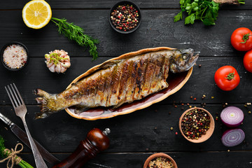 Baked Trout with Vegetables. Top view. Free space for your text. Rustic style.