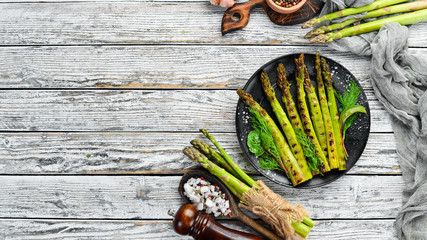 Green asparagus grilled with spices. Healthy food. Top view. Free space for your text.