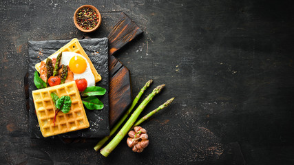 Breakfast. Belgian waffles with egg, asparagus and bacon. Healthy food. Top view. Free space for your text.