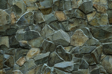Stonework texture. Green grey stone wall background. Masonry of decorative tile. Abstract pattern of gray rocks wall. Texture of old stone wall. Dark granites facade of building. Grunge rock texture.