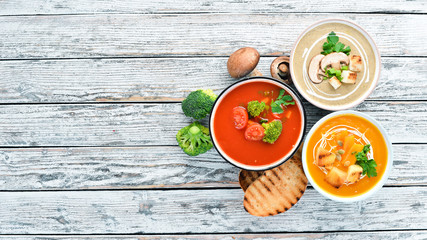 Variety of colorful vegetables cream soups. Concept of healthy eating or vegetarian food. Top view. Free copy space.