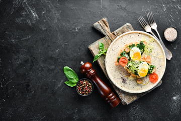 Sandwich with spinach, egg and tomatoes. croissant. Breakfast. In the plate. Top view. Flat lay...