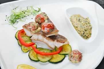 Baked fish fillet with vegetables. Top view. Free space for your text.