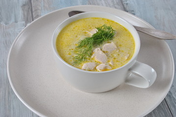 Chicken soup. Hot winter soup with chicken and potatoes. Chowder soup with chicken and potatoes. Fresh creamy soup with chicken and vegetablesin white bowl on the wooden background. Healthy food