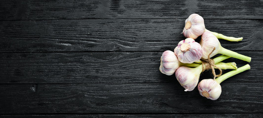 Fresh garlic on a wooden background. Top view. Free space for your text.