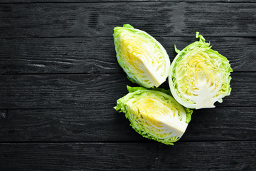 Fresh green cabbage on a wooden background. Top view. Free space for your text.