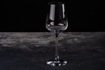 Empty glass of wine on black background
