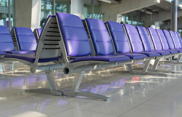 Row of purple chair at airport terminal waiting area