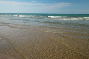 summer beach with clear blue sky and clouds
