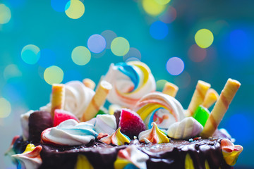 Holiday. Confectionery. Cake with sweets on a wooden background. Birthday.