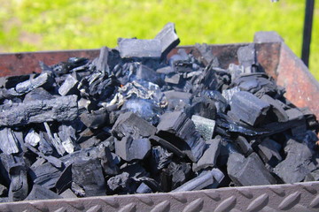 black coals for kindling a fire for cooking barbecue on the grill
