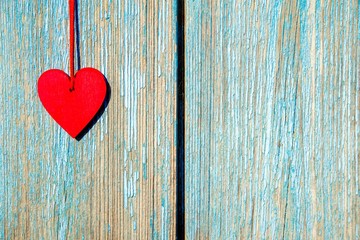 A symbol of love on blue wooden background 
