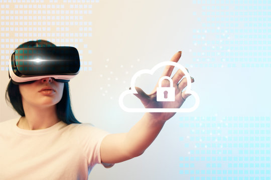 young woman in virtual reality headset pointing with hand at internet security illustration on beige and blue background - Powered by Adobe