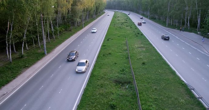 chasse through the forest top view. high-speed passing cars on a wide road, car traffic