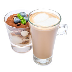 Classic tiramisu dessert with blueberries in a glass and cup of coffee isolated on a white background with clipping path