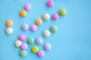 Colorful candies on blue background