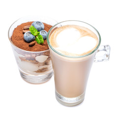 Classic tiramisu dessert with blueberries in a glass and cup of coffee isolated on a white background with clipping path
