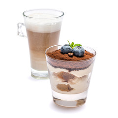 Classic tiramisu dessert with blueberries in a glass and cup of coffee isolated on a white background with clipping path