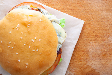 delicious juicy burger with blue cheese, copy space, flat lay