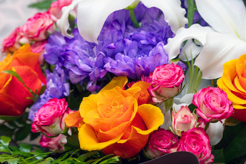Blue chrysanthemums, orange and pink roses in a beautiful bouquet. Selective focus
