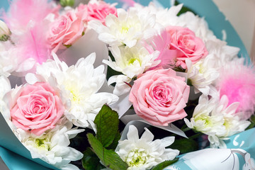 Beautiful and delicate bouquet of pink roses and white chrysanthemums. Selective focus