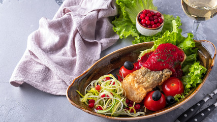 Tasty baked sturgeon fish with tomatoes and red sauce served with wine. Copy space