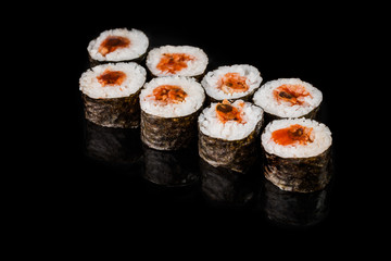 Sushi Roll - Maki Sushi pieces collection with Salmon Roe, Smoked Eel, Cucumber, Cream Cheese, Sesame, Avocado, Onion Fries, Crab Meat, Tobiko isolated on black background - Image