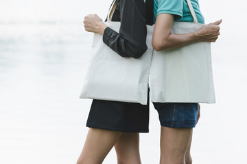 women carry bag on nature background in save earth concept or say no plastic bag.