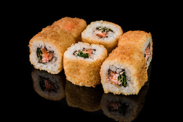 Sushi Roll - Maki Sushi pieces collection with Salmon Roe, Smoked Eel, Cucumber, Cream Cheese, Sesame, Avocado, Onion Fries, Crab Meat, Tobiko isolated on black background - Image