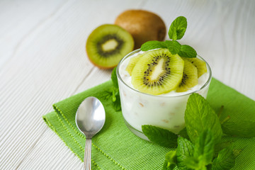Homemade proteic greek yogurt with kiwi, lemon and mint and healthy shack of kiwi, banana and lemon