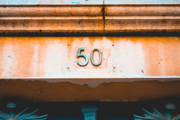number 50 door sign in golden letter