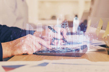 Abstract holographic city on man's hand writing notes background. Double exposure.