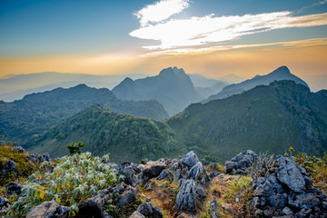 Golden Cloud and sunset sky at wildlife sanctuary name Doi Luang Chiang Dao, Thailand with Shadow of mountain layer and sun ray.