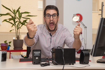 businessman, in the office, with gesture of joy, exaltation