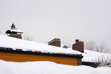 house in snow on roof