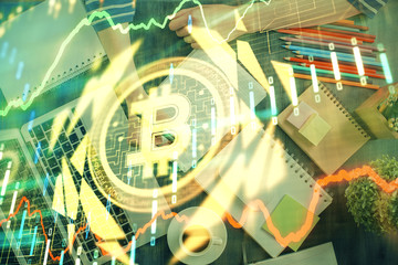 Cryptocurrency hologram, bitcoin, ico theme over hands taking notes background. Concept of blockchain. Multi exposure