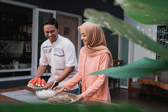 young hijab woman and boyfriend prepare cuisine for breaking fast serve to friends in the house at afternoon