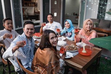 friends gathering  enjoy the iftar meal in the backyard house