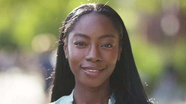 Portrait of healthy young black female looking and smiling to camera