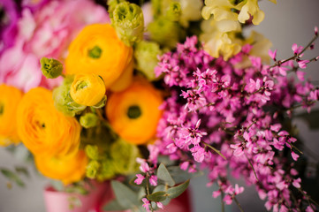 Close up spring box of tender yellow, green and pink flowers