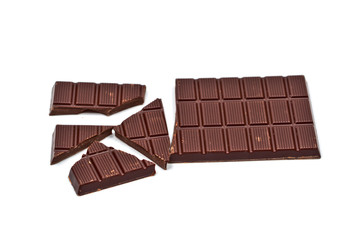 Broken dark chocolate bar isolated on white.