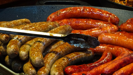 greasy fat porc sausages being sold as a snack for visitors of traditional Christmas markets in Prague (Praha), capital of Czech Republic, Bohemia region, Central Europe