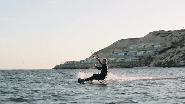 Female Kiteboarder Performs Small Jump Trick
